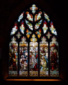 A stained glass window in a dark room