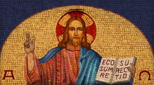 a mosaic of jesus holding a book