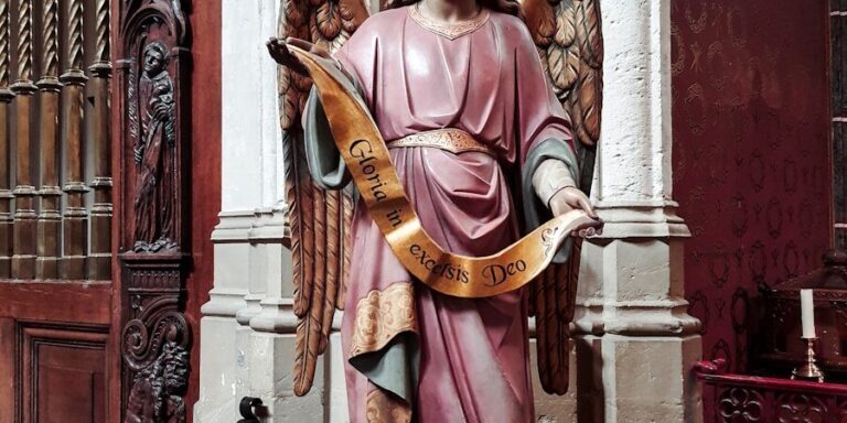 A statue of an angel holding a harp